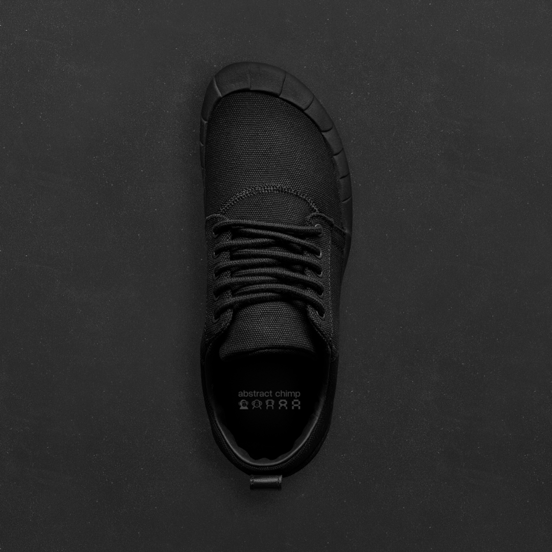 Black fission.01 viewed from above, showing the wide forefoot and stitched upper